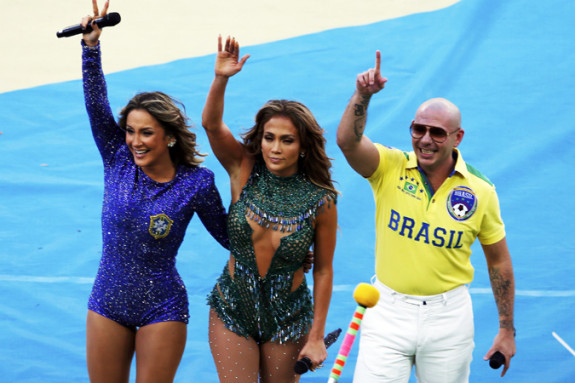 Singers Leitte, Lopez and Pitbull wave after performing during the 2014 World Cup opening ceremony at the Corinthians arena in Sao Paulo