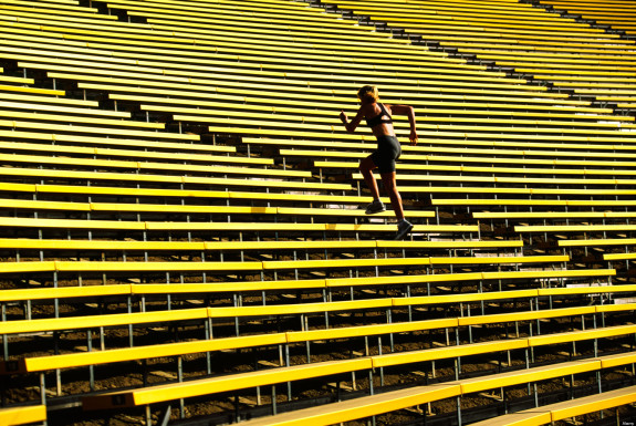 Model released woman running up stadium stairs